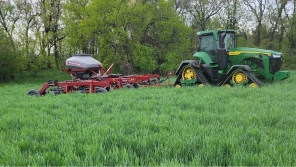A tractor no-tilling into cereal rye.