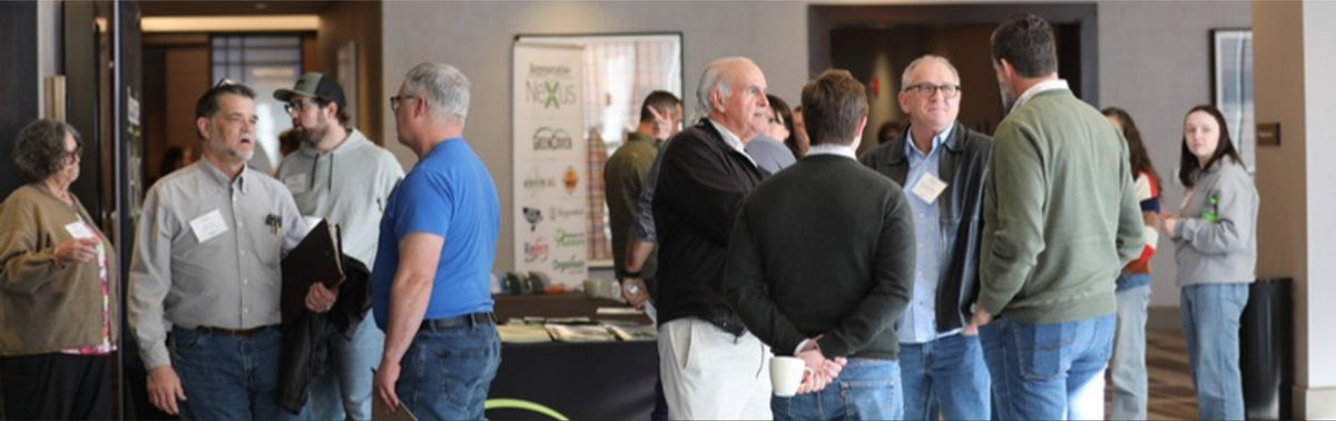 Sponsors and producers talking between sessions at a Regenerative Nexus