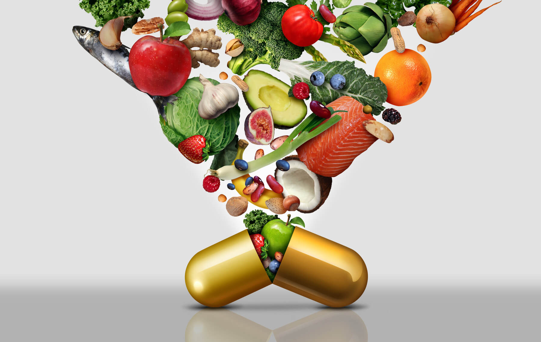 A golden pill capsule filled with healthy fruits, vegetables, and proteins like fish to promote human health
